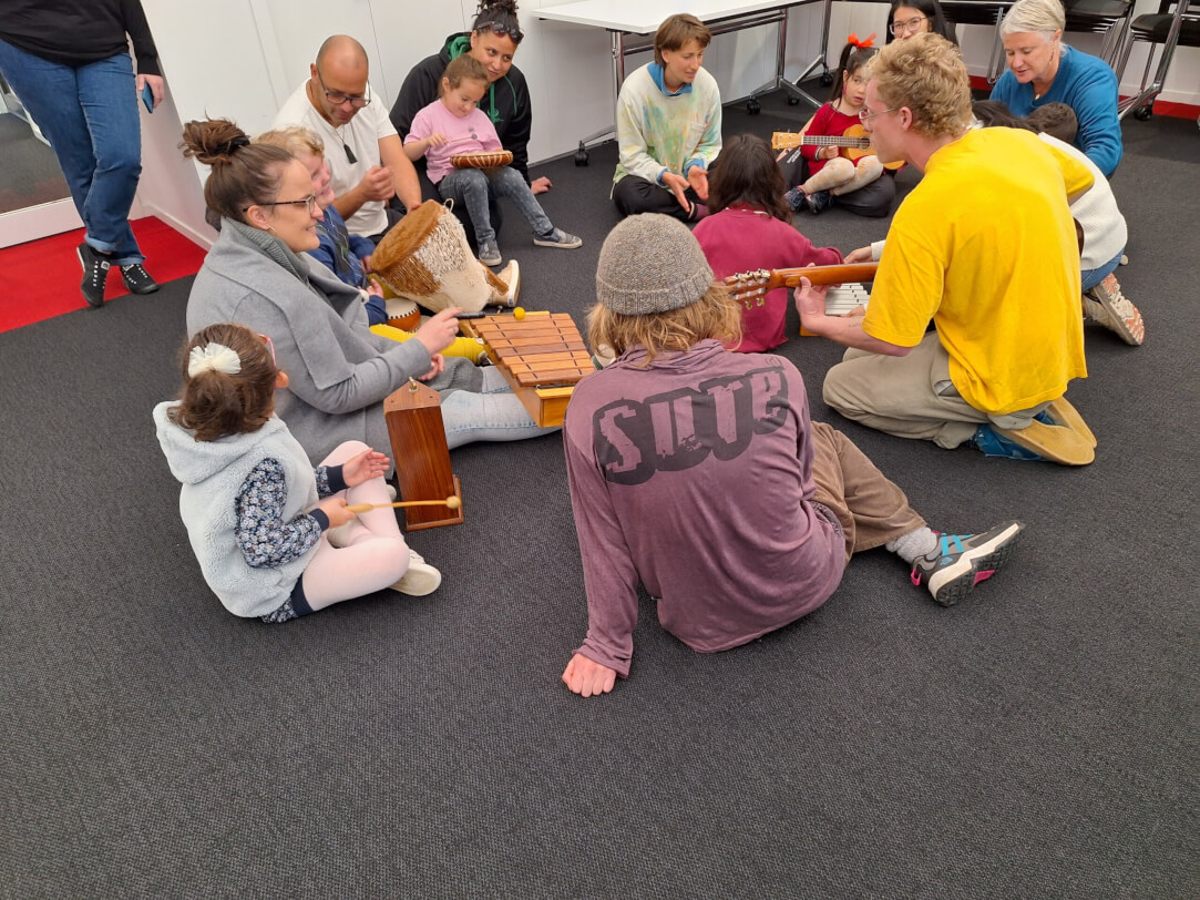 Figure 1 - Wellington BLENNZ ākonga and a group of first year Music Therapist students from Victoria University School of Music are siting on the floor with musical instruments for a morning of singing, dancing and having fun