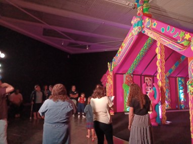 Figure 2 - Ākonga and whānau standing in front of the wharenui and listening to a description about what is represented on the front panels.